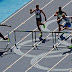 Nicholas Kiplagat runs into a hurdle