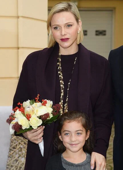 Princess Charlene wore a wool cashmere brown coat and brown long sleeve wool midi dress by Louis Vuitton