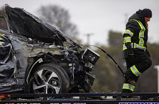 A crumbled car is towed as emergency crews work to clear the mass casualty pile-up on I-35W and Northside Drive in Fort Worth. (Juan Figueroa/The Dallas Morning News via AP)
