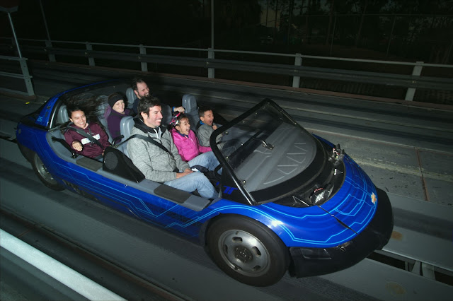 My husband and I on the Test Track ride at EPCOT FIVE || Buy Memory Maker So you can get your picture taken for free from PhotoPass photographers around the parks. They're stationed at photo-opp places like in front of the castle as well as with the characters. Any time any of them takes a picture of you with their professional cameras and photography skills, they scan your ticket (whether that's a card or Magic Band - more on that later) and your picture is then connected to your account. You can find all your PhotoPass pictures on your MDE app or online at the Disney Store here. Your ride photos are there too. The problem is, they have a watermark and you have to pay to download each photo you want. Unless you have Memory Maker. It's about $150 - $200 (depending on when and how you buy it) and you can download any and all photos on your account and do whatever you want with them. I especially recommend doing this if it's just the two of you going because you're going to want some pictures of the two of you together.