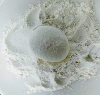 Dusting egg into flour for scotch eggs recipe