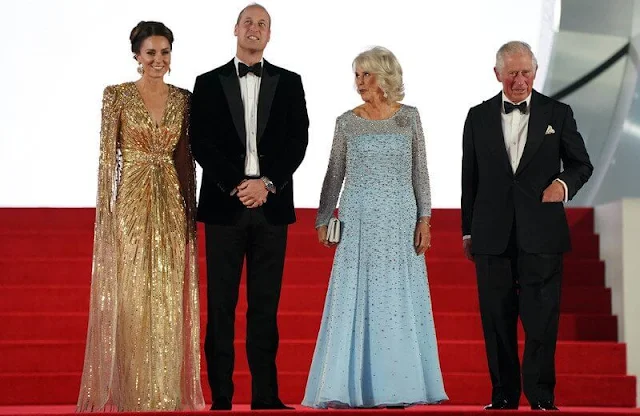 Kate Middleton wore a shimmering cape gown by Jenny Packham. Gold earrings. Aquazzura Fenix gold metallic leather pumps