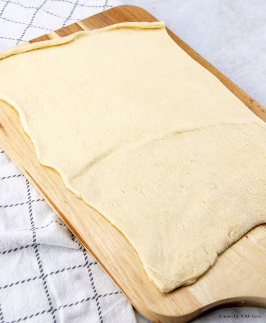 Cutting board with crescent rolls spread out