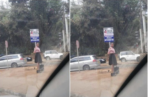 1 Kenyan lady stands on the road to plead for a job