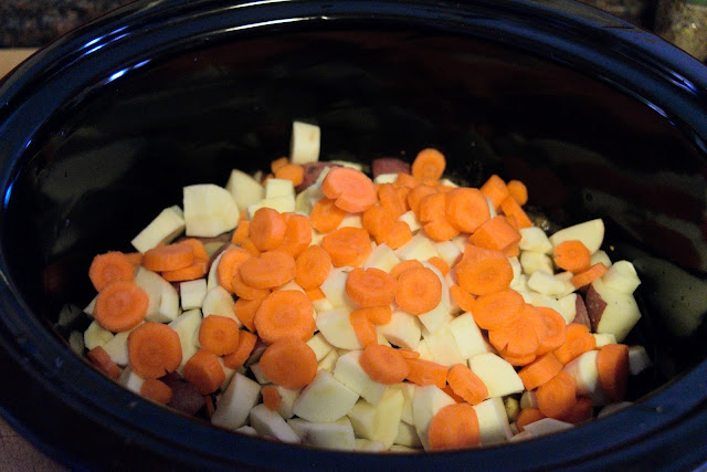 Carrots being added to the crock pot. 