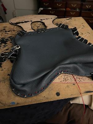 The body being sewn to the back, please note the back strap has already been stitched on.