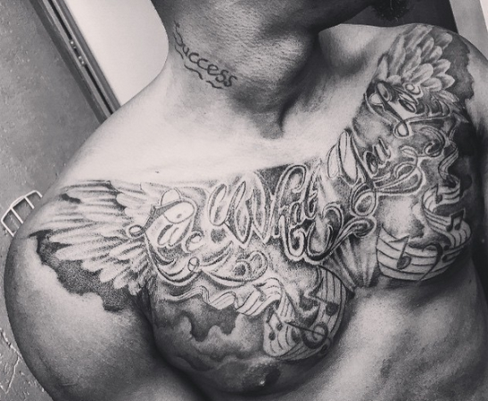 a Oh my! Check out Sean Tizzle's new chest Tattoo