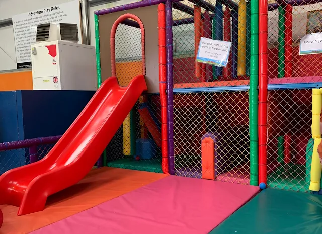 Younger children's soft play area at Barleylands with a red slide and padding visible