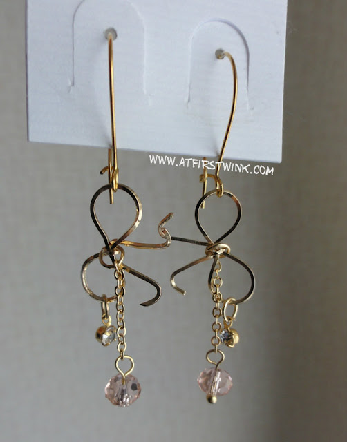 3Coins Japan gold ribbon earrings with small pink crystal