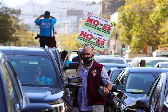Drivers and other gig workers urging voters to reject California’s Proposition 22 outside Uber’s headquarters