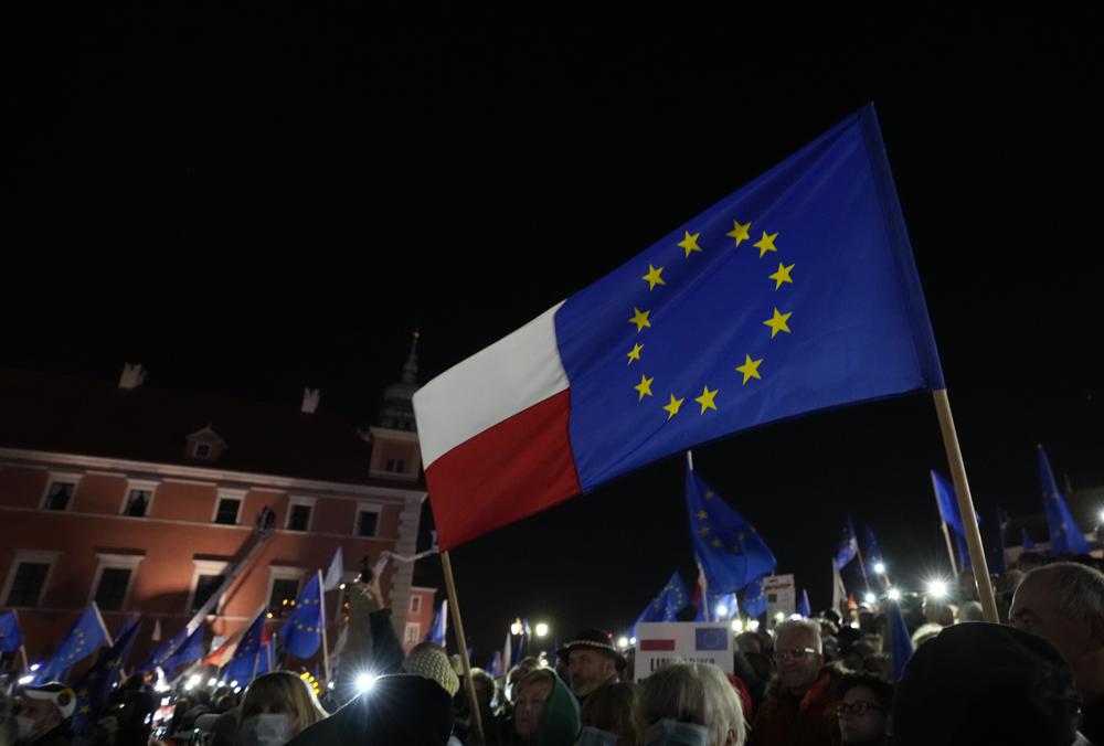 People wave EU and Polish flags in support of Poland’s EU membership during a demonstration in Warsaw, Poland