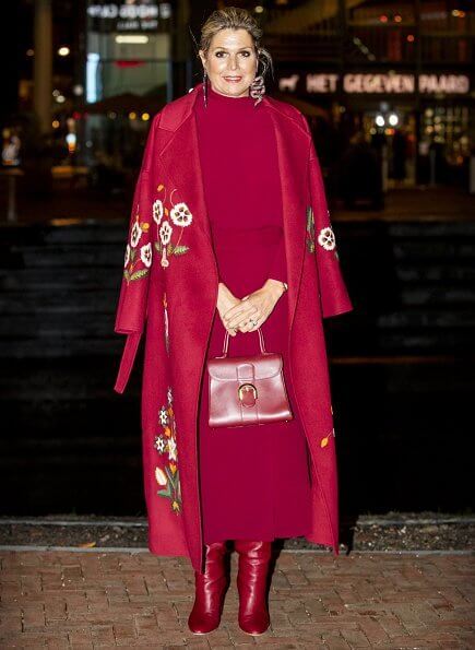 Queen Maxima wore a claret multi embroidered wool cashmere coat from Oscar de la Renta, and a red open-back midi dress from Massimo Dutti