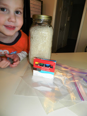 Young boy at kitchen counter with jar of plane rice