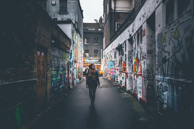Girl walking down graffiti street