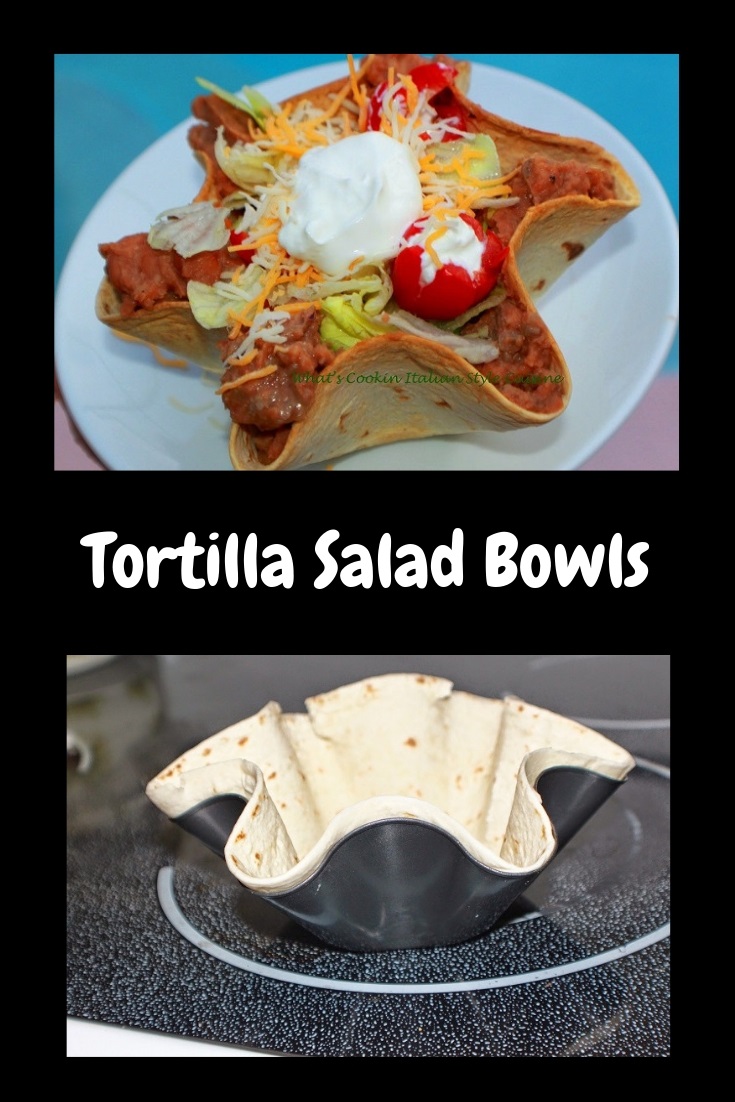this is a taco flour tortilla bowl filled with salad ingredients like shredded lettuce, tomatoes, shredded cheese, ground beef, topped with sour cream  and taco sauce on top or salsa