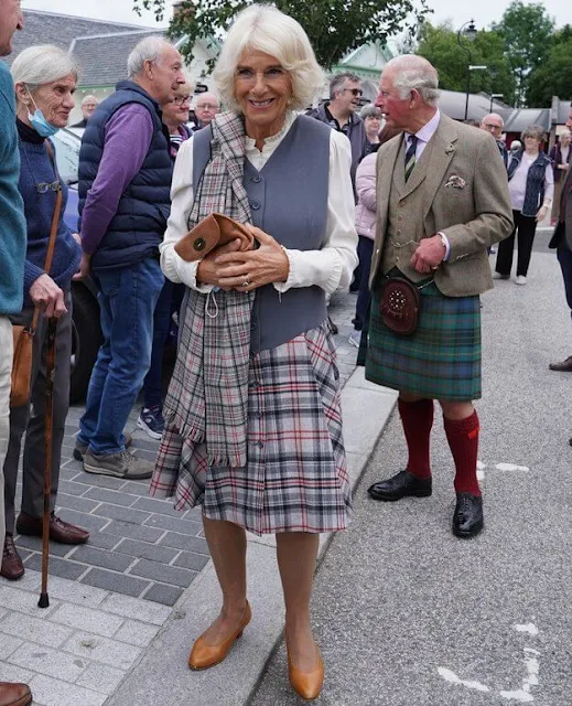 Duchess of Cornwall wore a chic check dress that featured a unique grey waistcoat style top