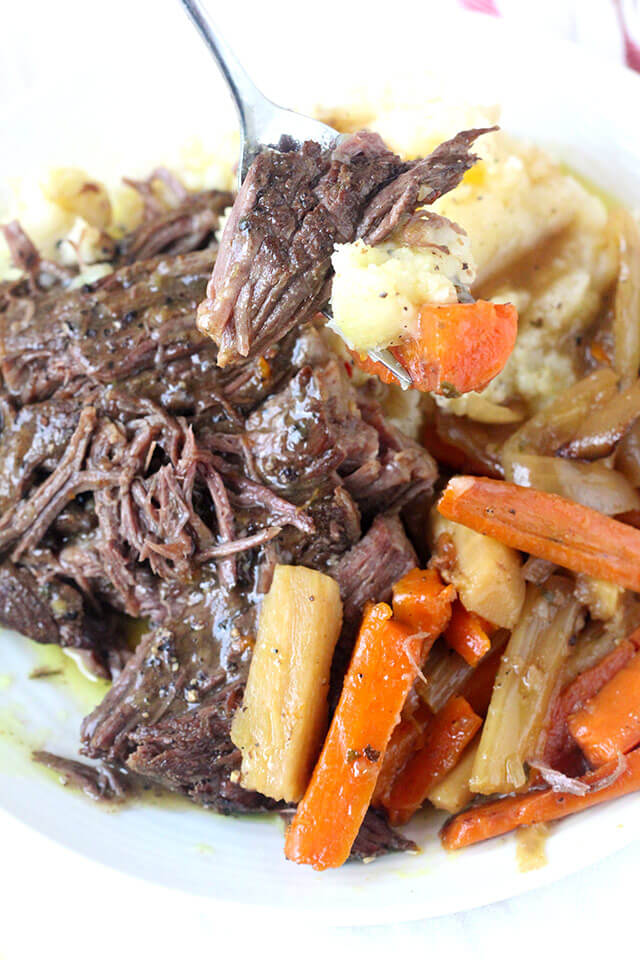 Fall-apart tender pot roast cooked in the crock-pot with root vegetables and homemade onion soup mix. This super easy recipe takes about 20 minutes to prep and can be made in as little as 4-5 hours on the high setting. Serve with your favorite mashed potatoes  for a comforting meal.