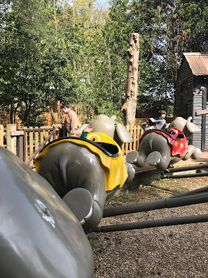 View of the flying jumbo ride from one of the elephants showing the rear of the elephants in front