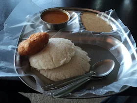 Two bikes parked in front of a small, welcoming highway hotel