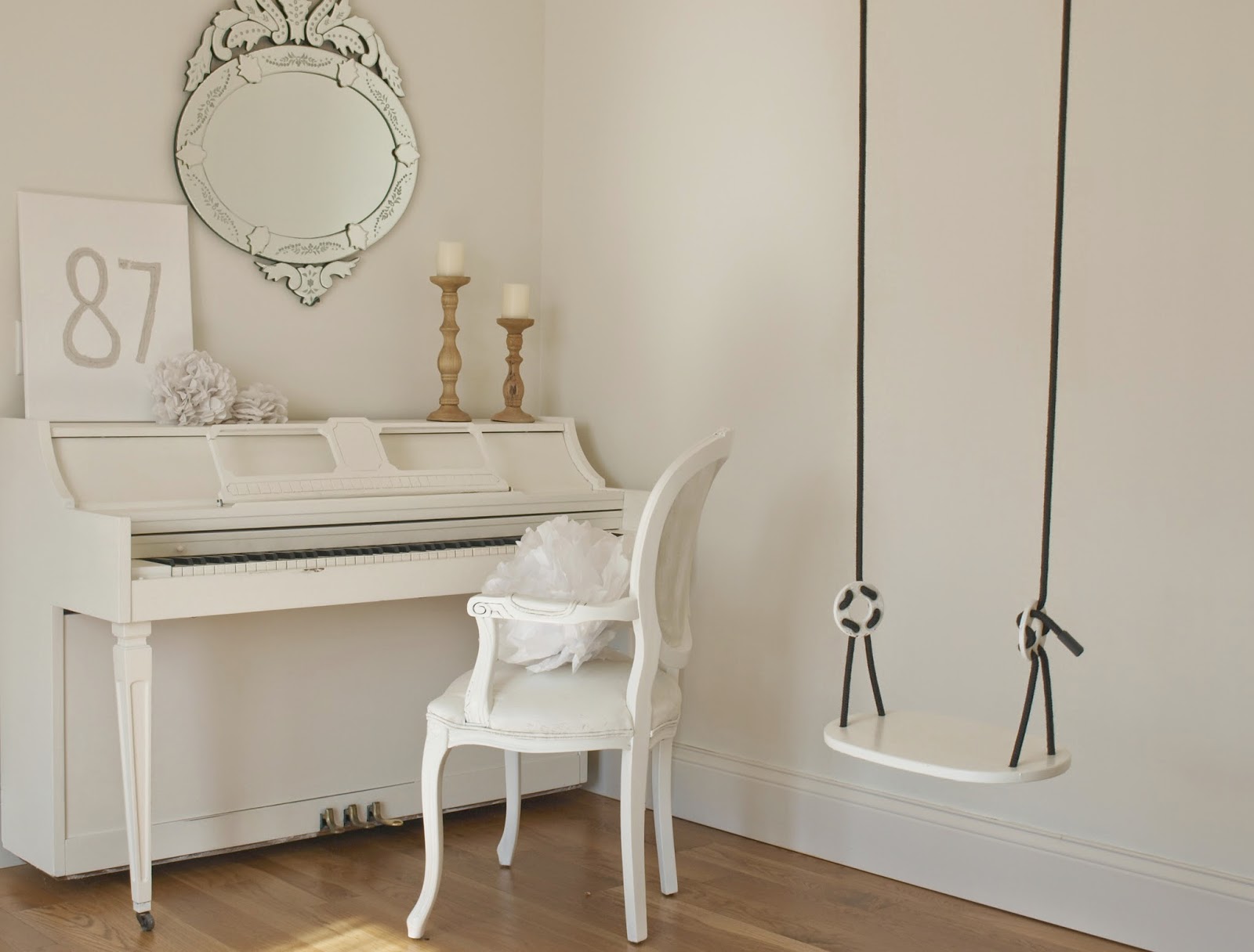 Hello Lovely Studio white piano, French chair, and swing in studio