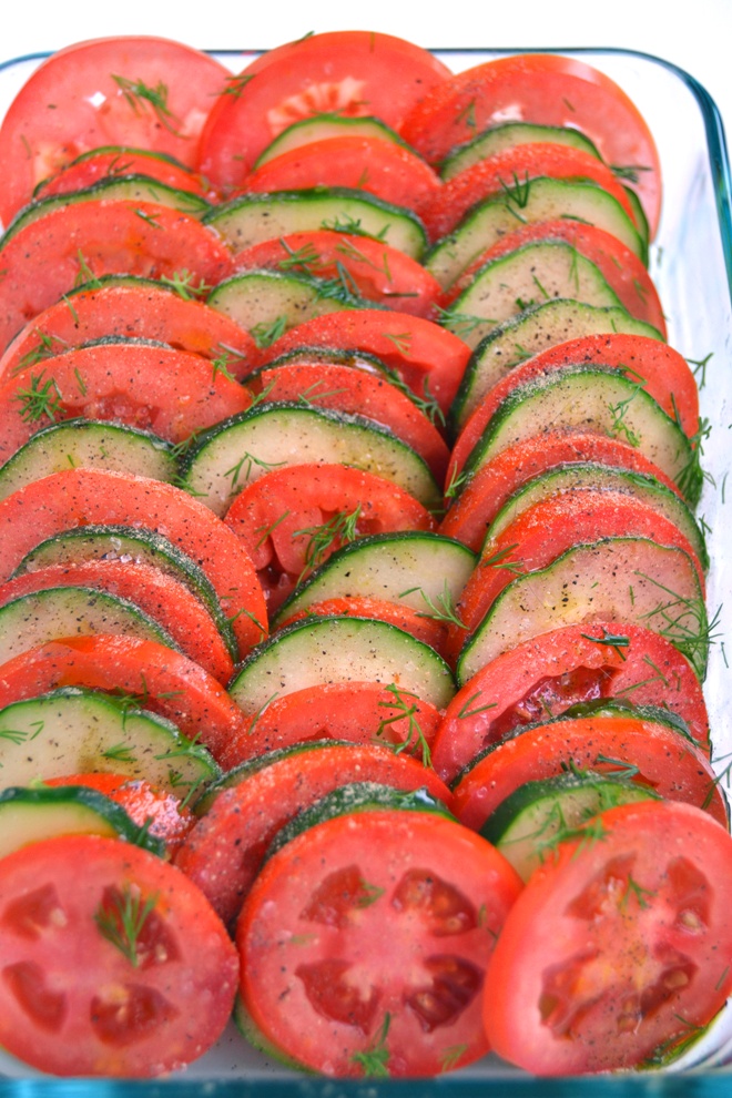 Layered Tomatoes and Cucumbers is the perfect side dish that takes just 5 minutes to make. Thinly sliced fresh cucumbers and tomatoes drizzled in a homemade dill vinaigrette! www.nutritionistreviews.com