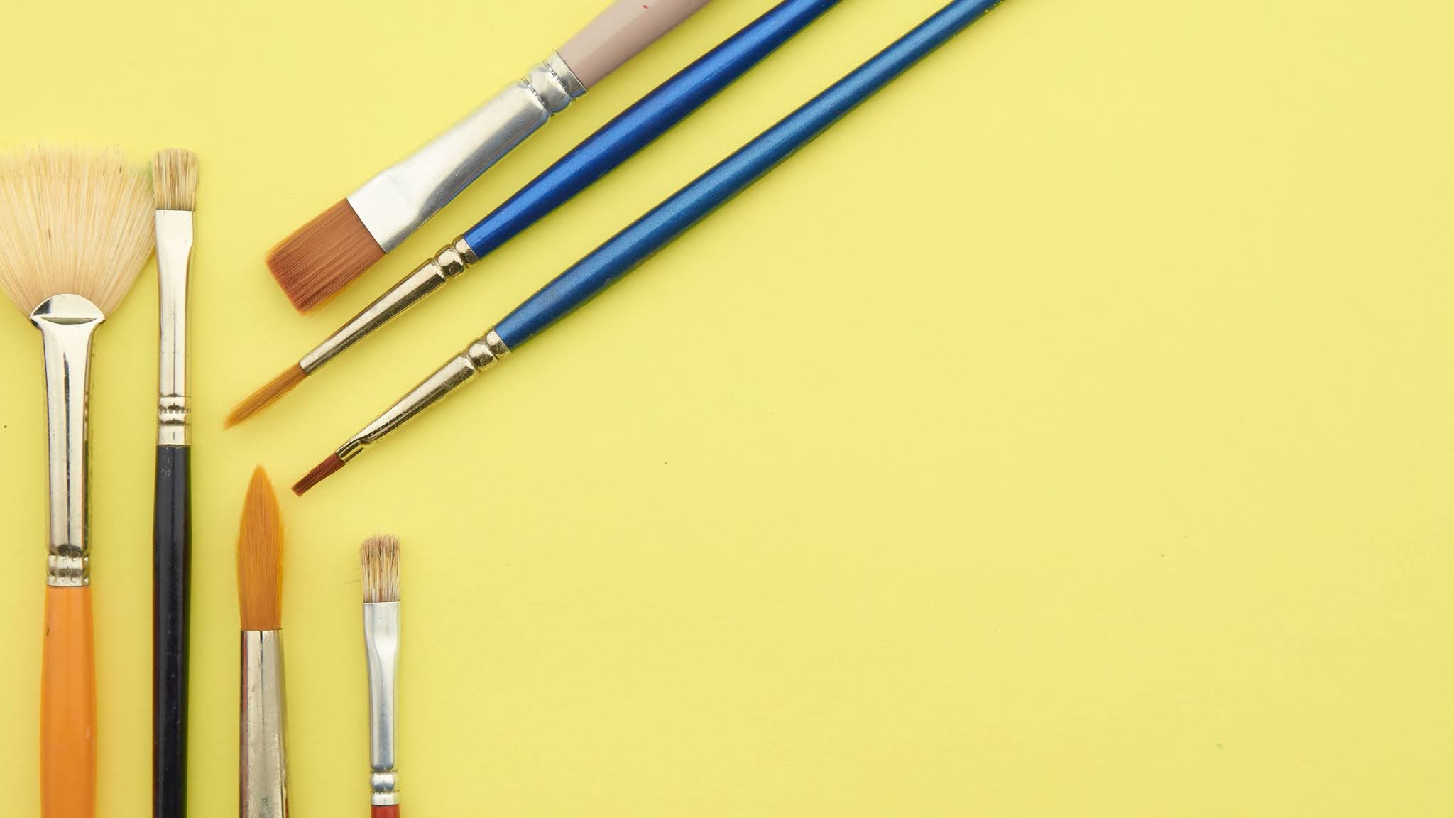 Paint Brushes On Yellow Background