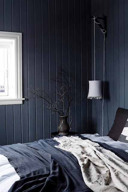 A black cottage in Iceland decorated in blue-grey tones