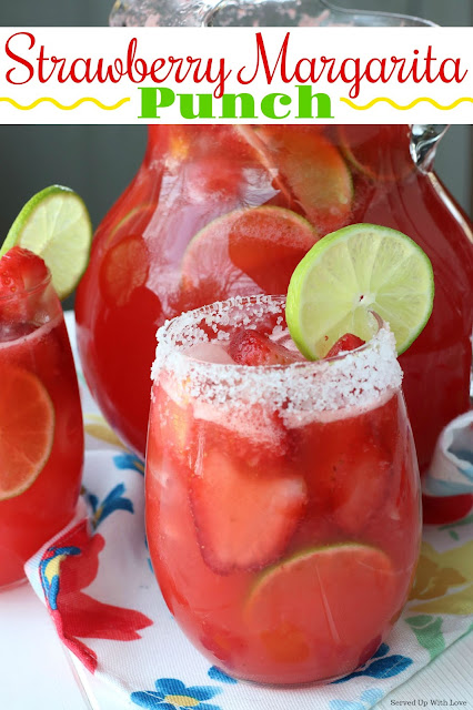 Strawberry Margarita punch in glasses with salt around the rim with a lime slice