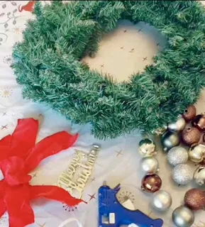 Supplies needed for making a DIY handmade holiday wreath.