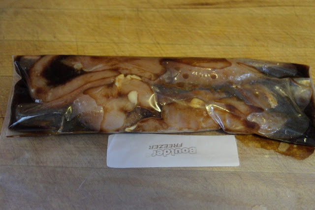 The chicken marinating in a resealable bag. 