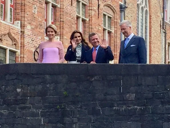 Queen Mathilde and Queen Rania visit Bruges, Belgium. Queen Rania wore Louis Vuitton dress and Louis Vuitton bags. Queen Mathilde wore Natan dress