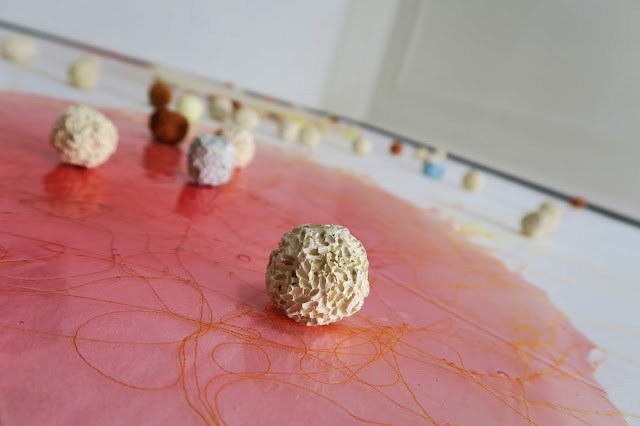 "Riso Amaro" VSC install: Approximately 47 x 59 inches. Acrylic paint skins, thread, terra cotta, porcelain, stoneware rice balls. 2019