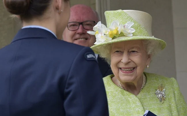 Queen Elizabeth, wearing a lime green coat and the Wattle brooch presented to her on first tour of Australia in 1954