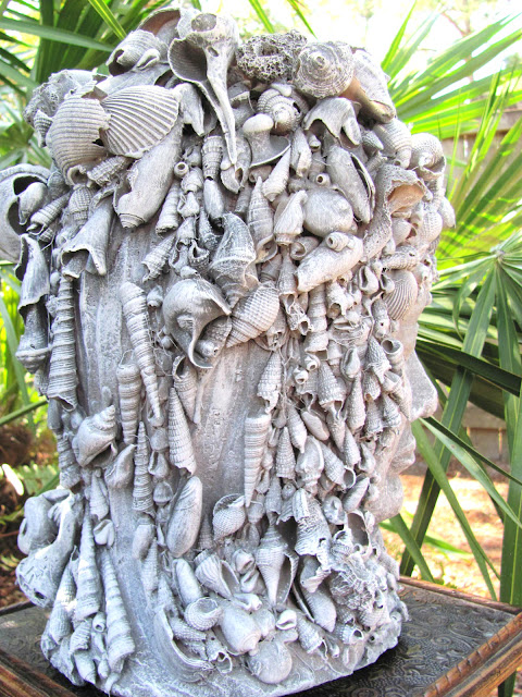 clay goddess statue with shells 