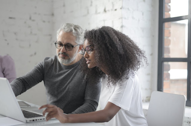 two co-workers discussing a social media marketing project