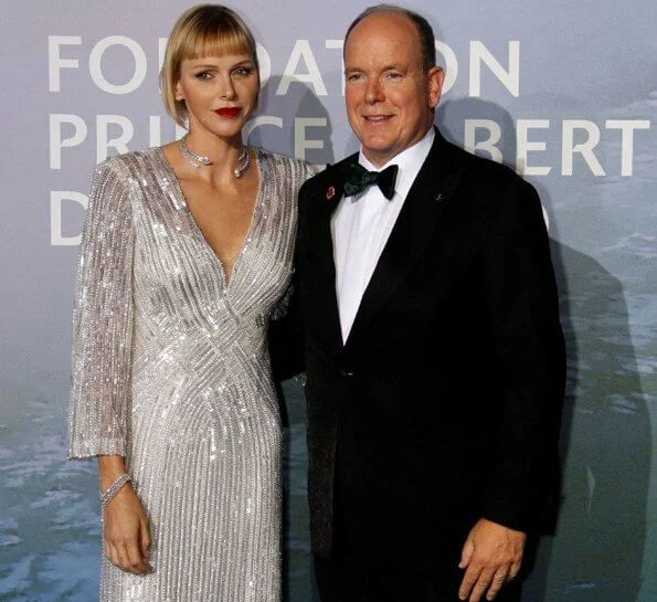 Princess Charlene wore a new v-neck sequin gown from Jenny Packham, and Brevis diamond necklace from Repossi. Pauline Ducruet red suit