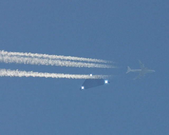 UFO Triangle seen behind a Jet aircraft.