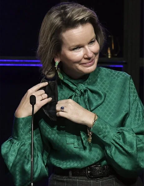 Queen Mathilde wore a new green bow blouse from Carolina Herrera and grey check print trousers from Natan. She visited the facilitys of Danone