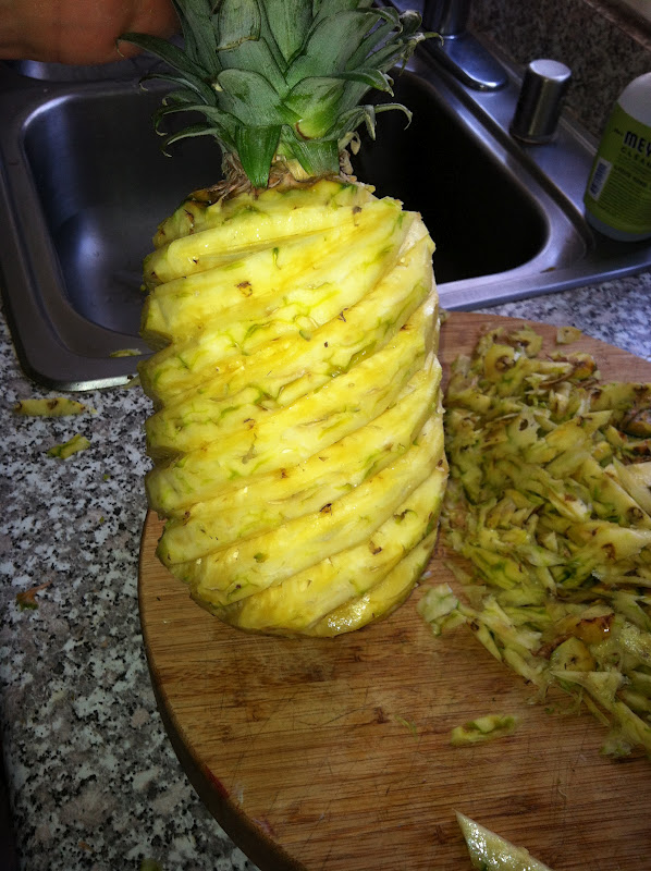 The Curried Cook Cutting a Pineapple