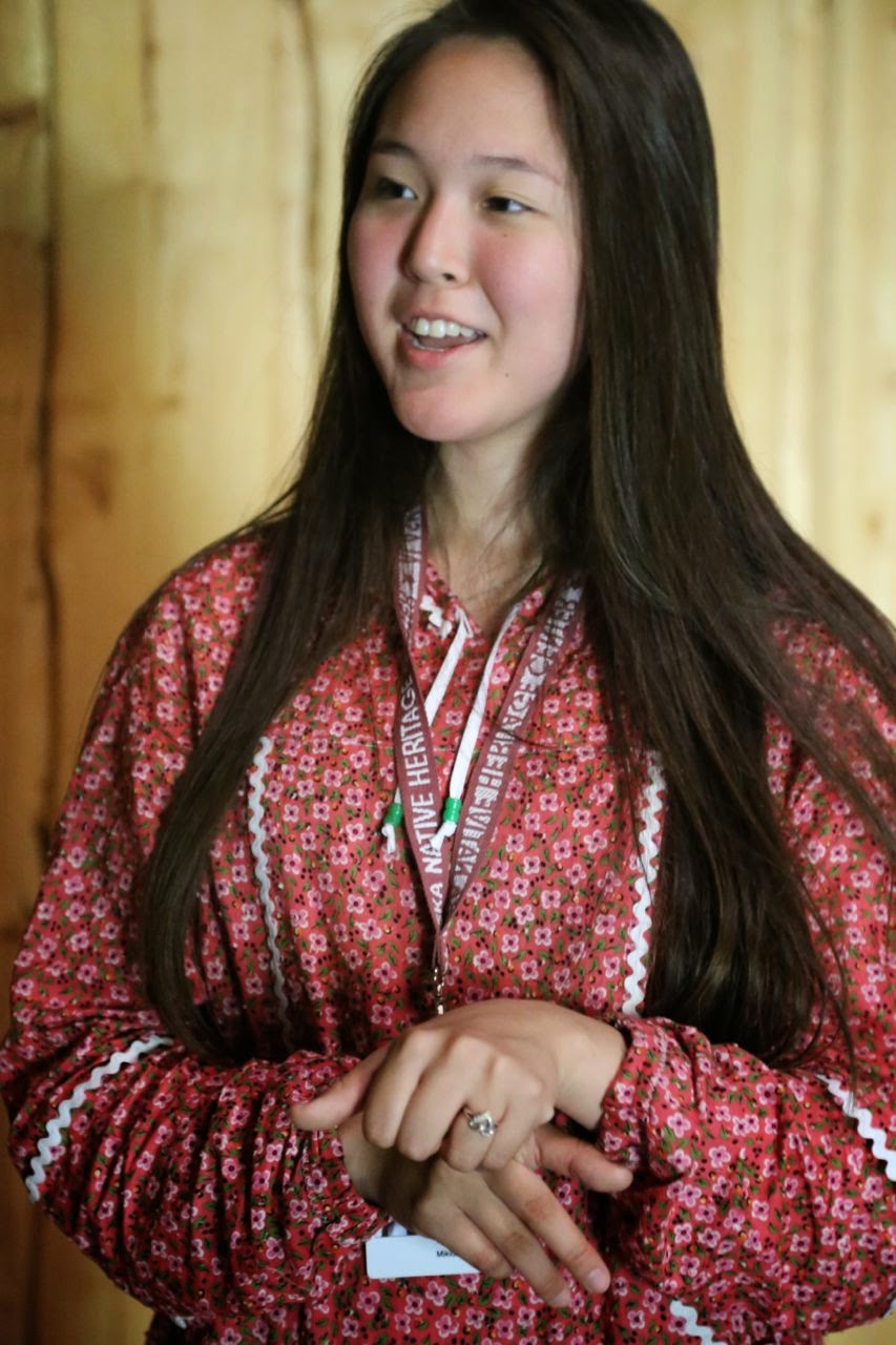 Native Alaskan girl explaining how men and women lived in separate houses. 