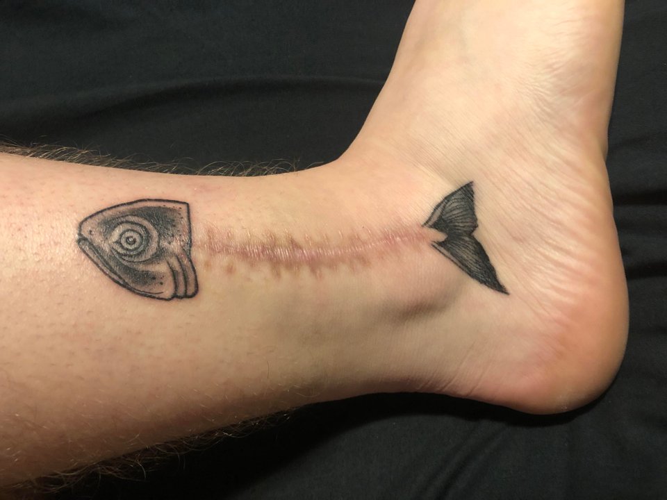 Single needle rose tattoo on the Achilles heel