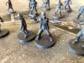 Carl and Rick Grime fight off the zombie horde in The Walking Dead: All Out War miniatures game