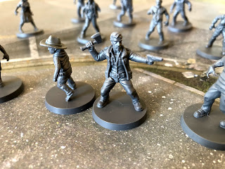 Carl and Rick Grime fight off the zombie horde in The Walking Dead: All Out War miniatures game