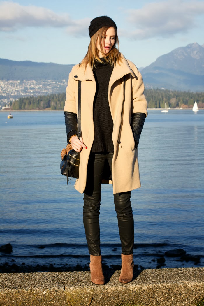 Fashion Blogger, Alison Hutchinson, is wearing a leather sleeve coat from Zara, H&M chunky turtleneck sweater, Current/Elliot wax coated jeans, Vince Camuto tan booties, a Rebecca Minkoff Leopard Print Bag, Michael Kors slim Runway Watch, and a Kate Spade gold bracelet