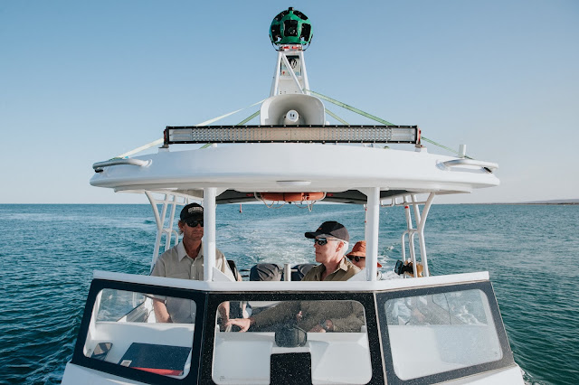Photo of Kerstin Stender from Parks and Wildlife Service WA and the Google Street View Trekker keeping an eye out for whale sharks as they cruise the Ningaloo Coast.