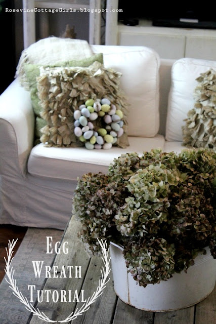 White couch with throw pillows and bucket full of hydrangeas | DIY Easter Egg Wreath