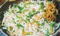 Prepared hakk noodles topped with chopped spring onions for hakka noodles veg recipe
