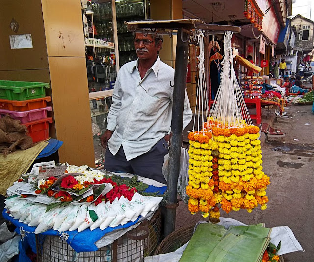 man selling flower garlands