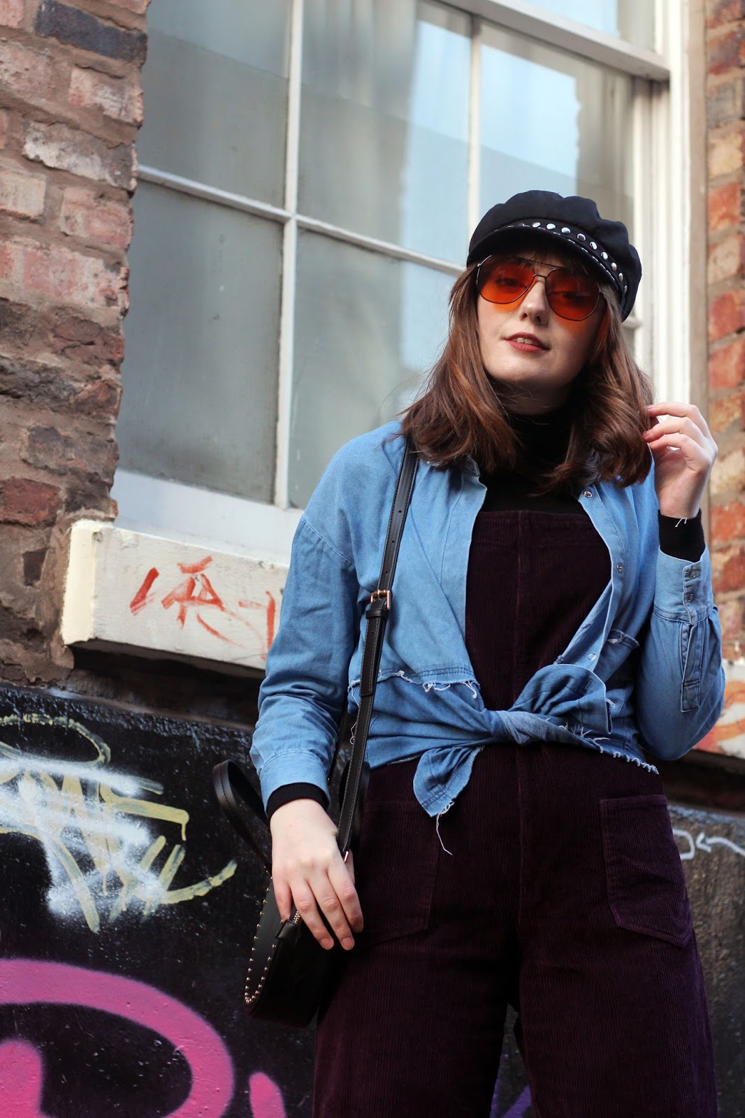 how to style dungarees seventies inspired, topshop baker boy hat, ASOS orange 70s sunglasses, denim shirt and cord dungarees with topshop black faux leather circle studded bag