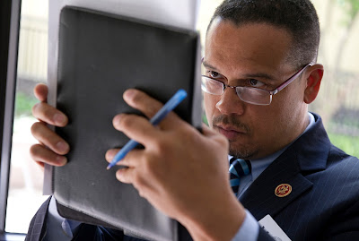 Keith Ellison studying notes on his iPad